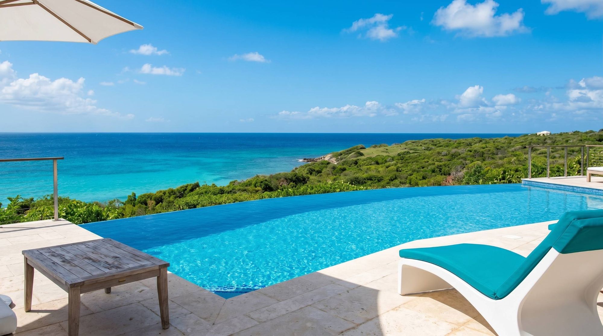 Infinity pool terrace with sea views and a lounge chair in the foreground.